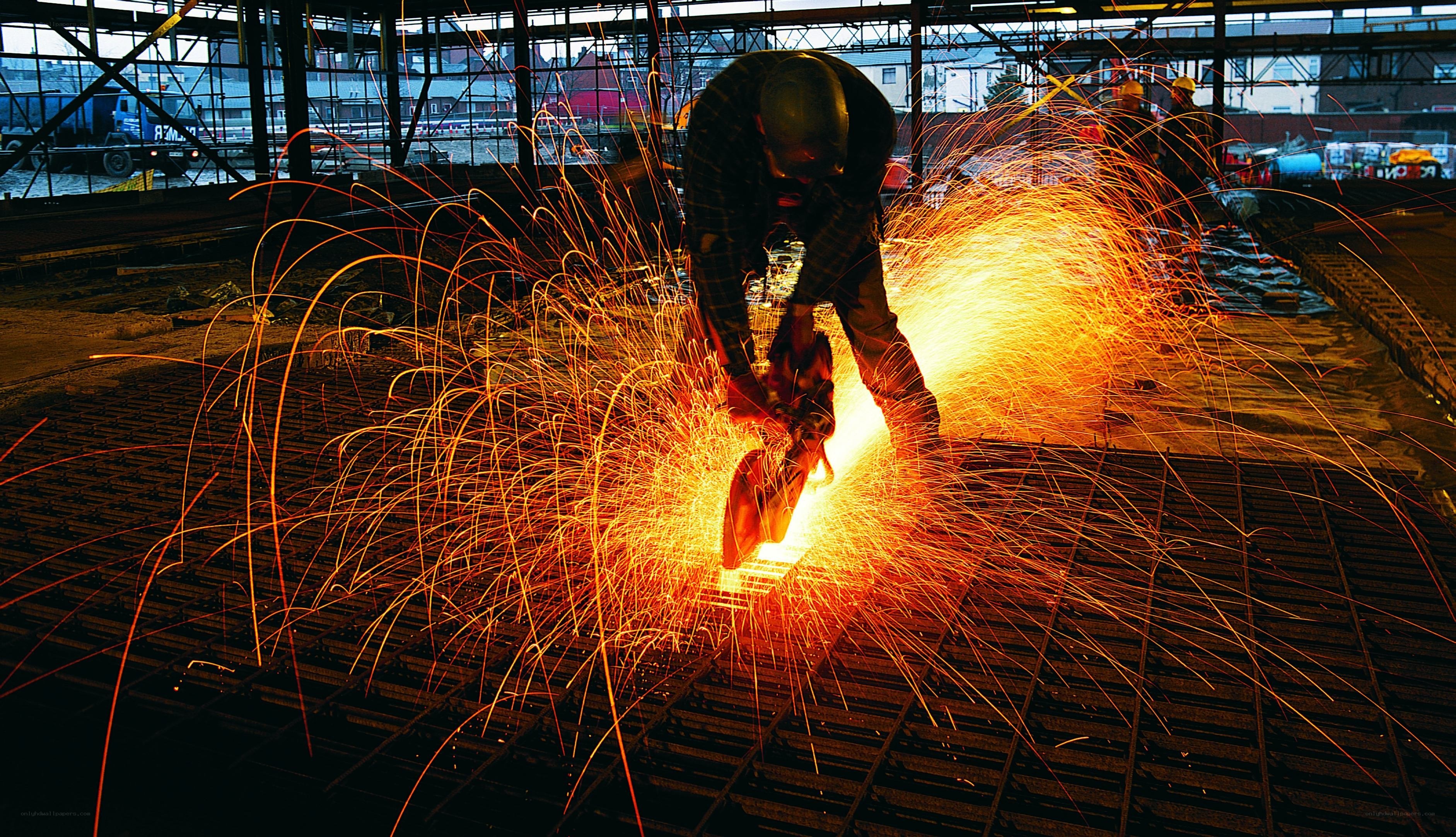 Worker cutting metal with sparks