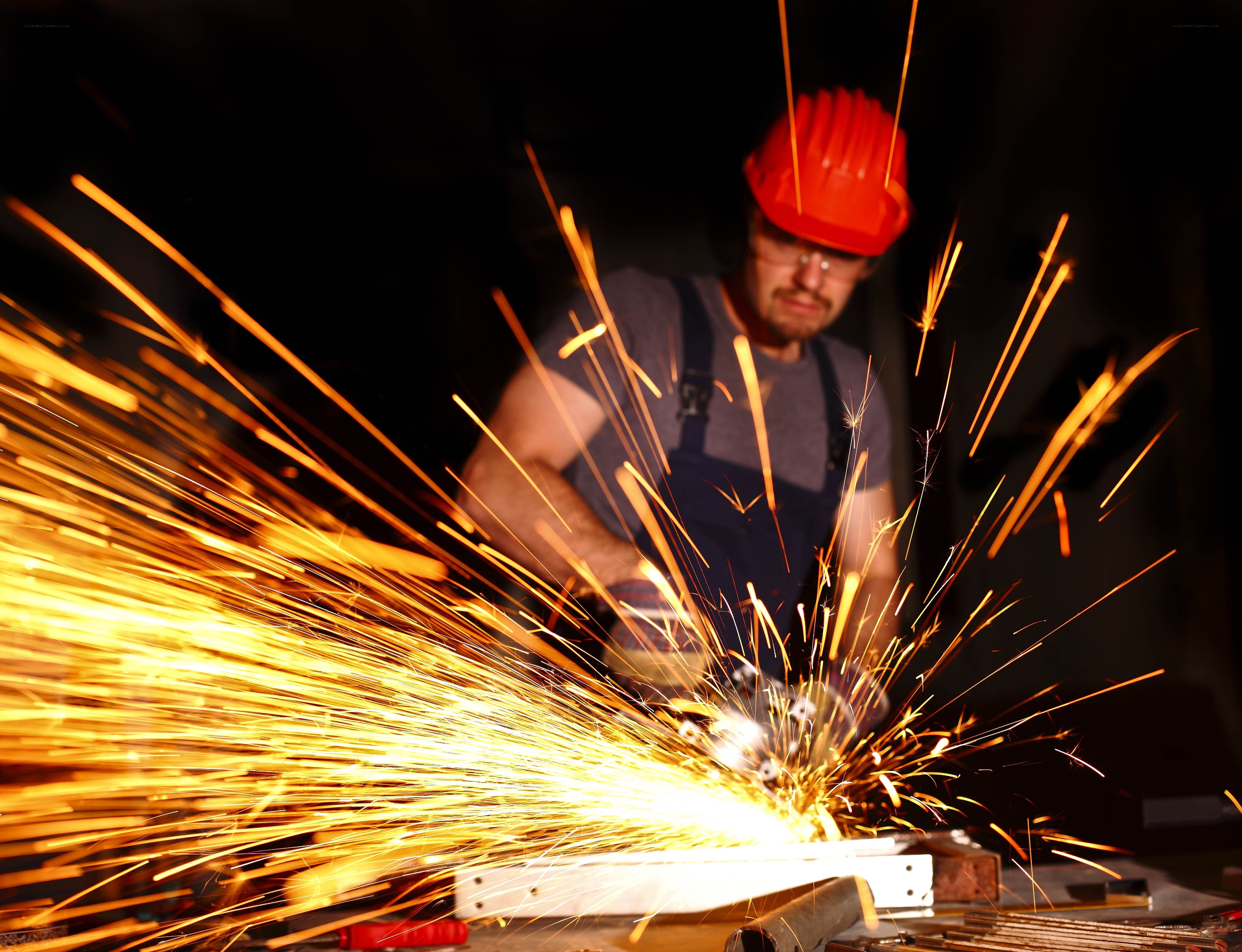Worker cutting metal with sparks