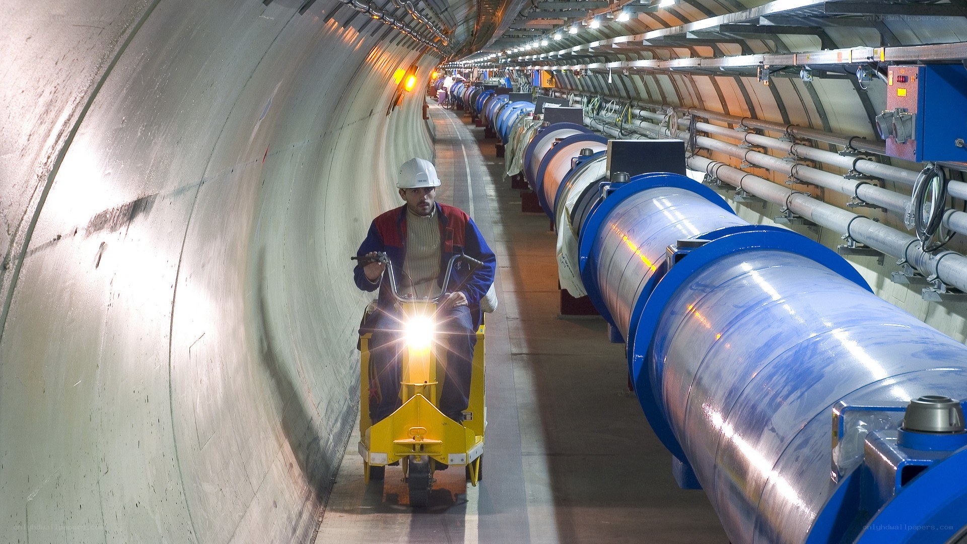 Worker in a particle accelerator tunnel