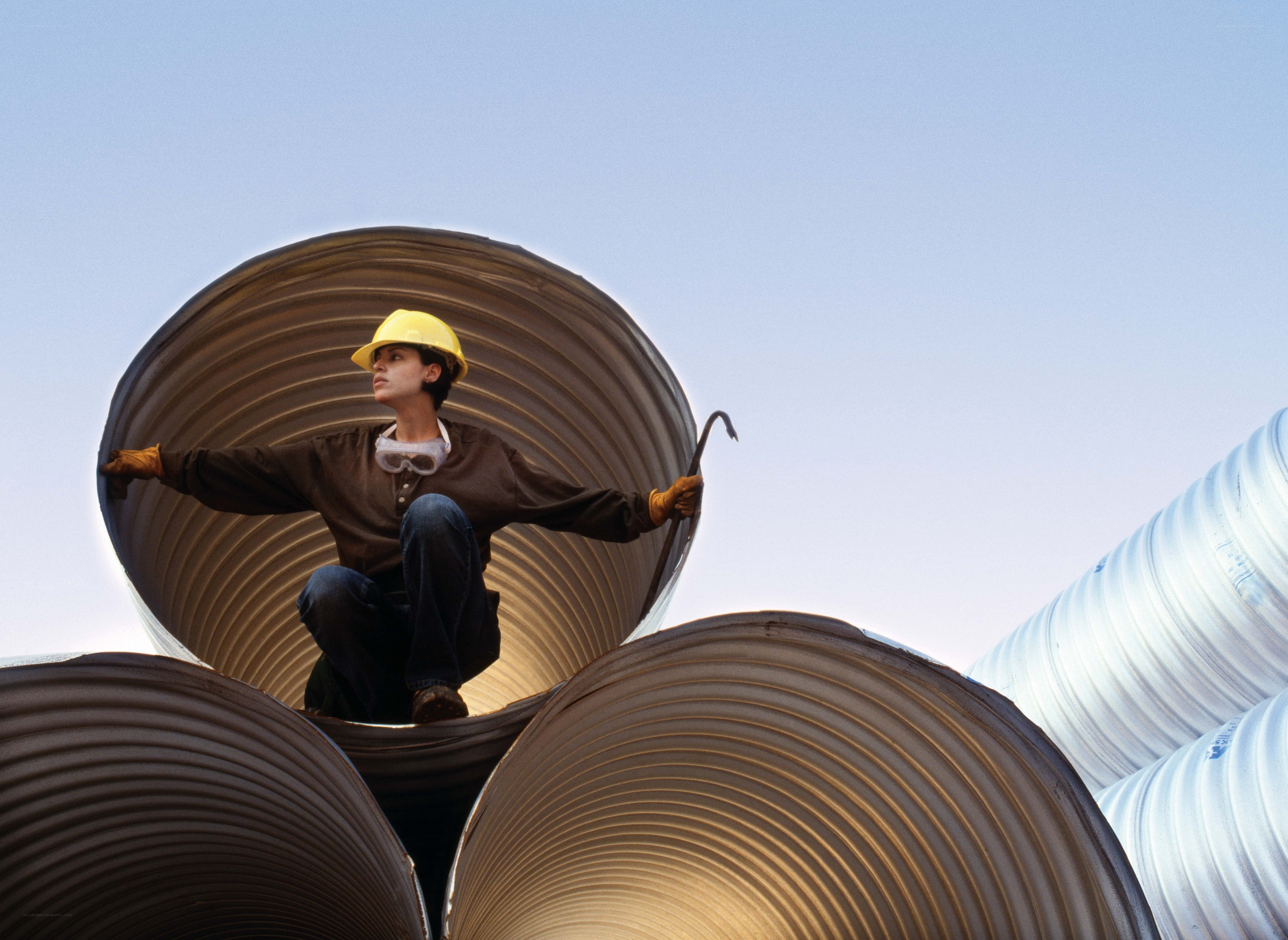 Worker on corrugated pipes