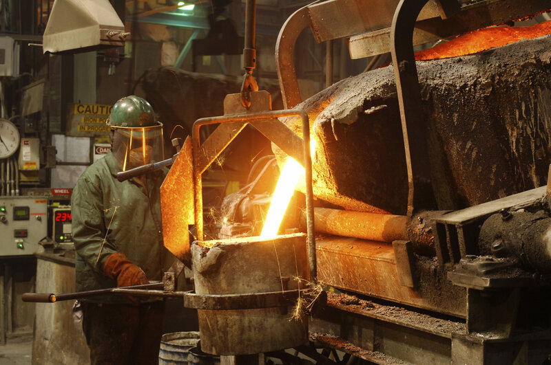 Worker pouring molten metal