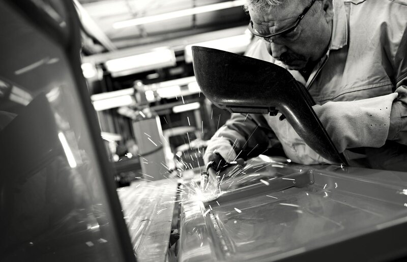 Worker welding car parts