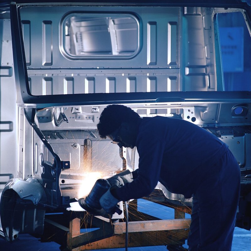 Worker welding vehicle frame