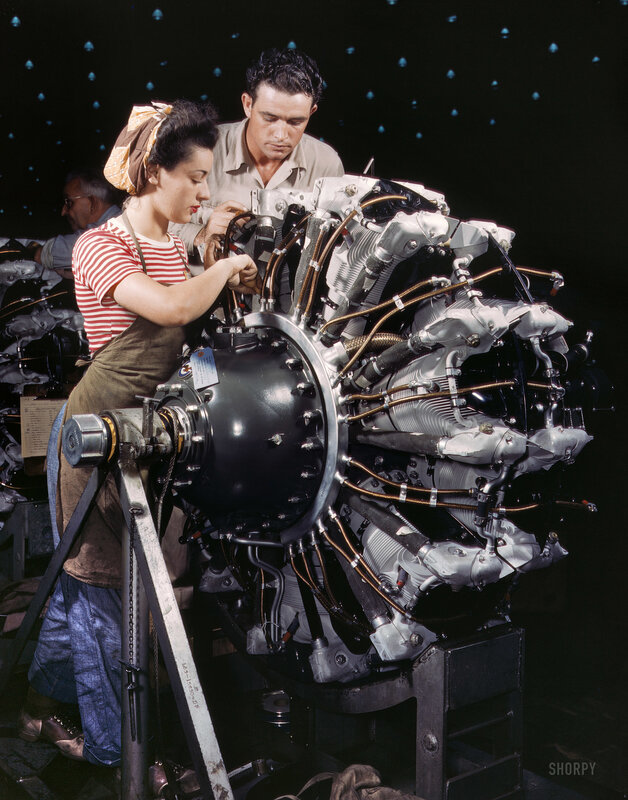 Workers assembling aircraft engine