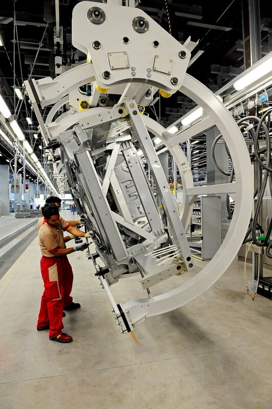 Workers assembling aircraft part