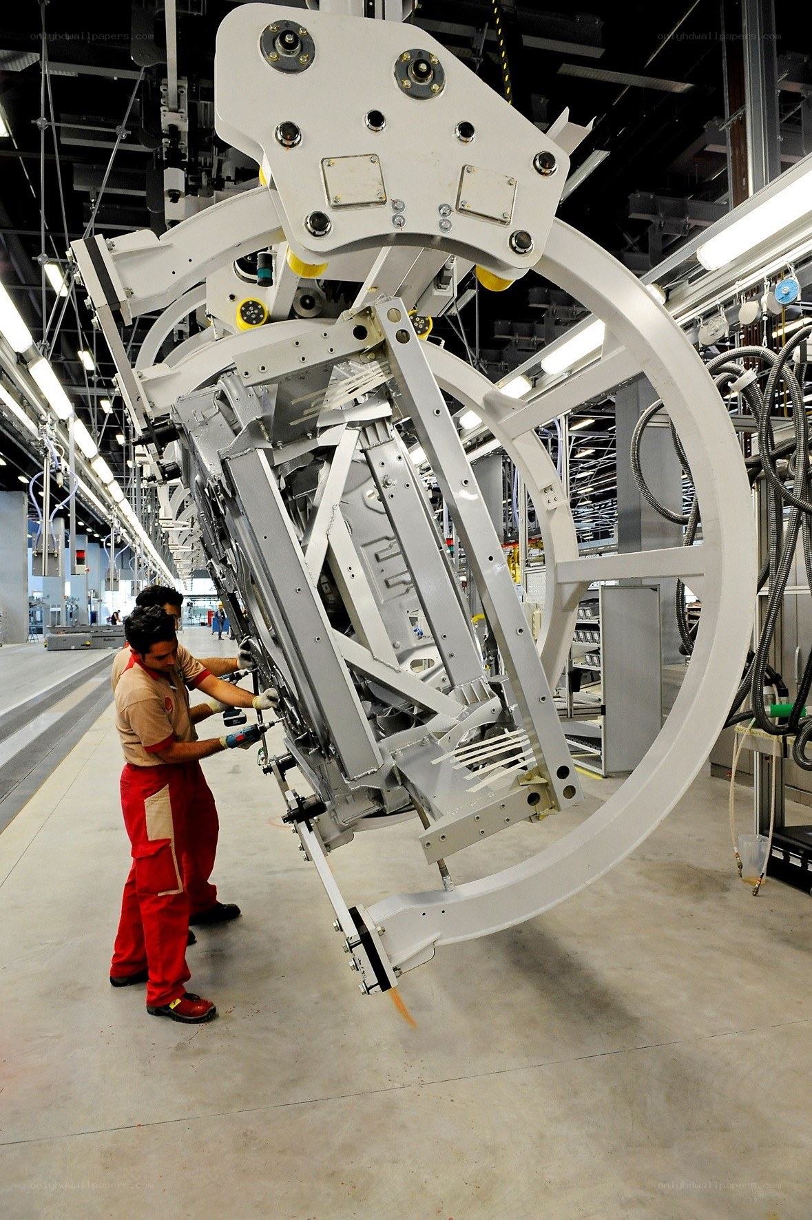 Workers assembling aircraft part