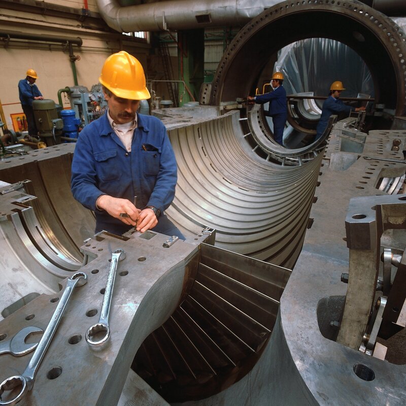 Workers assembling large machinery