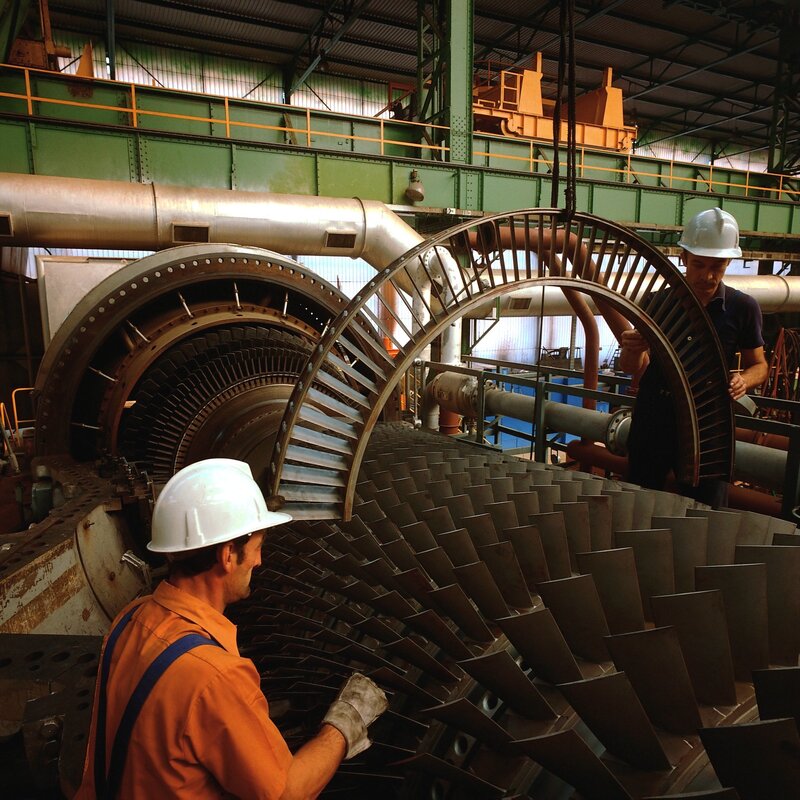Workers inspecting turbine blades