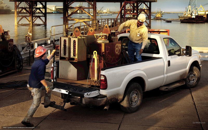 Workers loading equipment at port