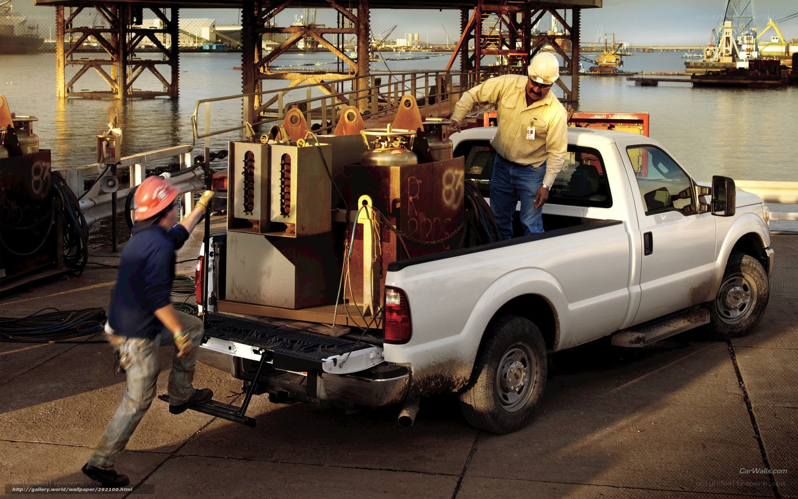 Workers loading equipment at port