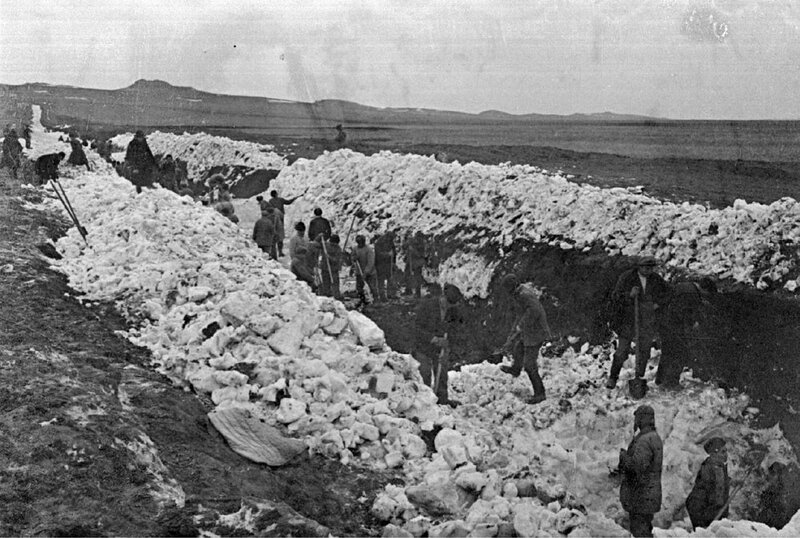 Workers mining ice in a field