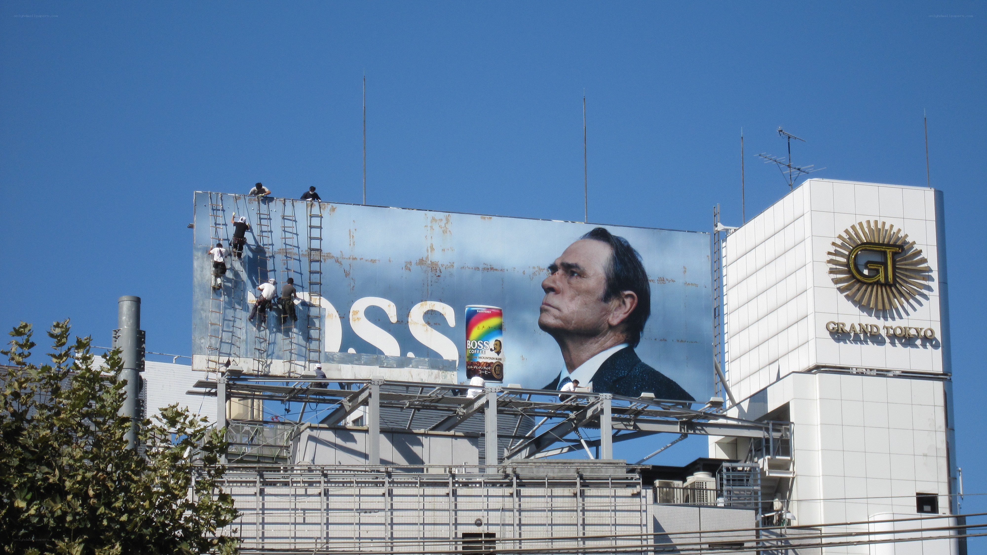 Workers on a billboard in Tokyo