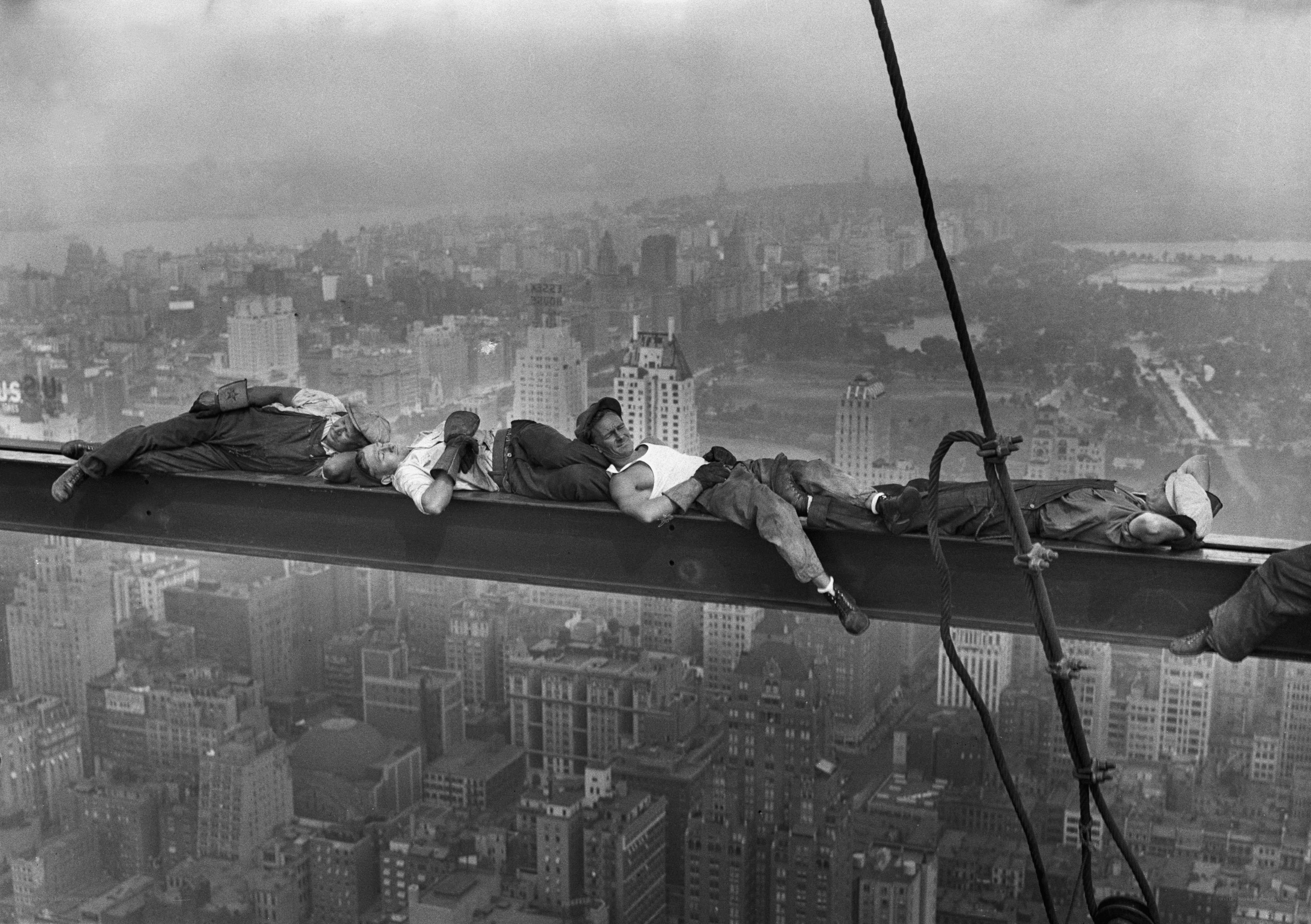 Workers resting on steel beam