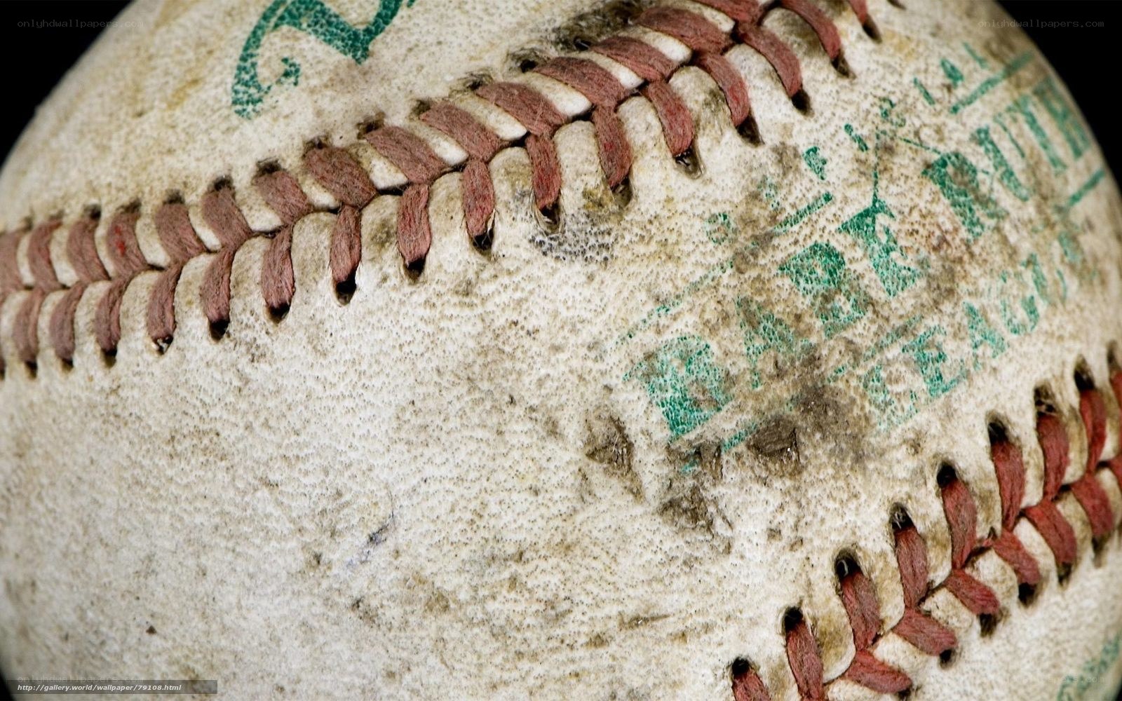 Worn baseball with green text