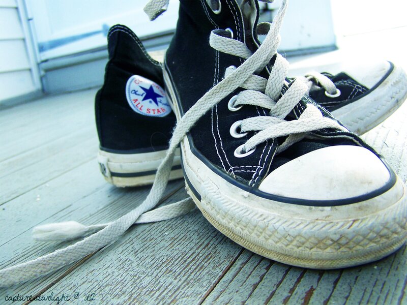worn black converse sneakers