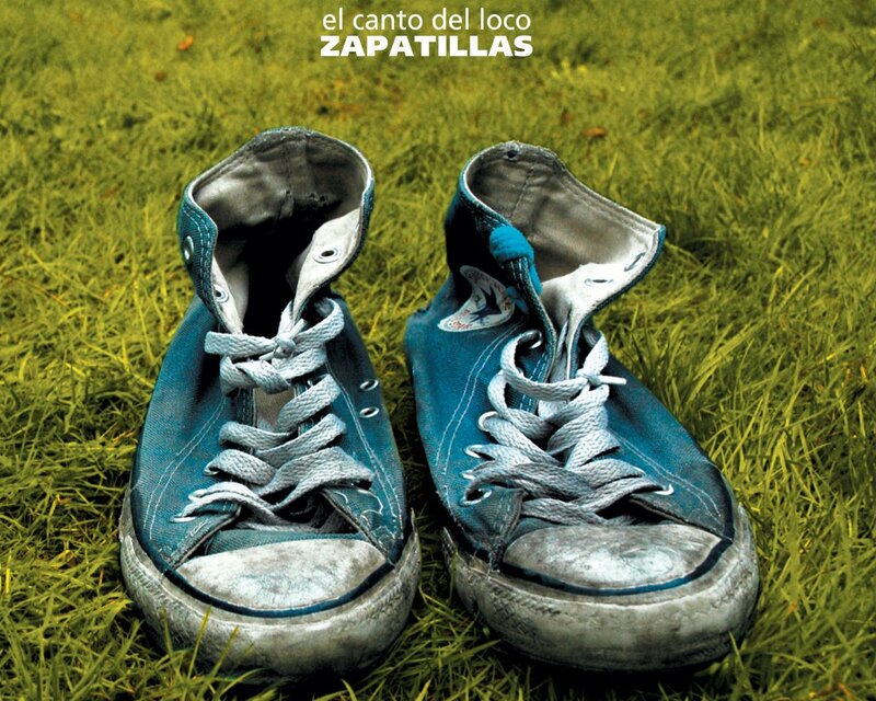 worn blue sneakers on grass