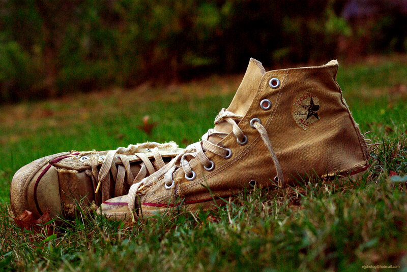 Worn-out Sneakers in Grass