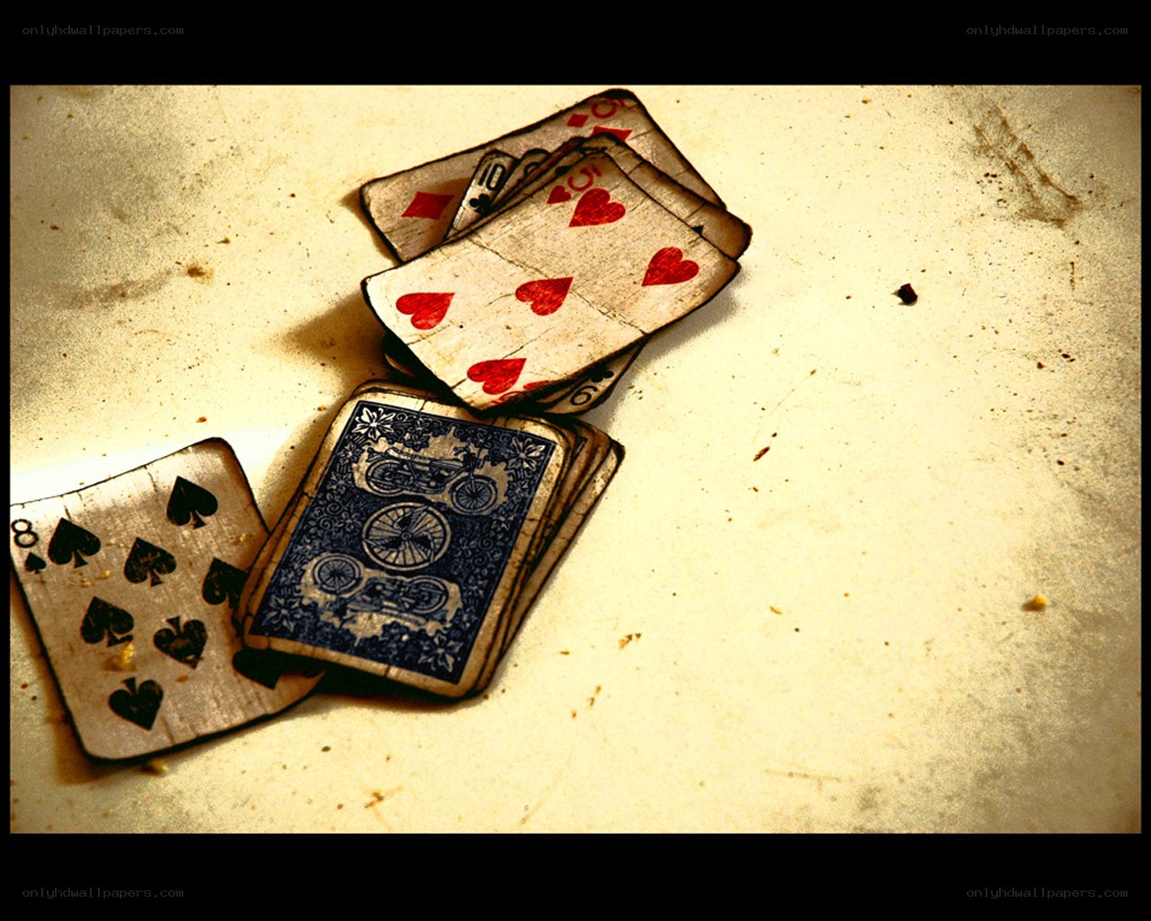 worn playing cards on a surface
