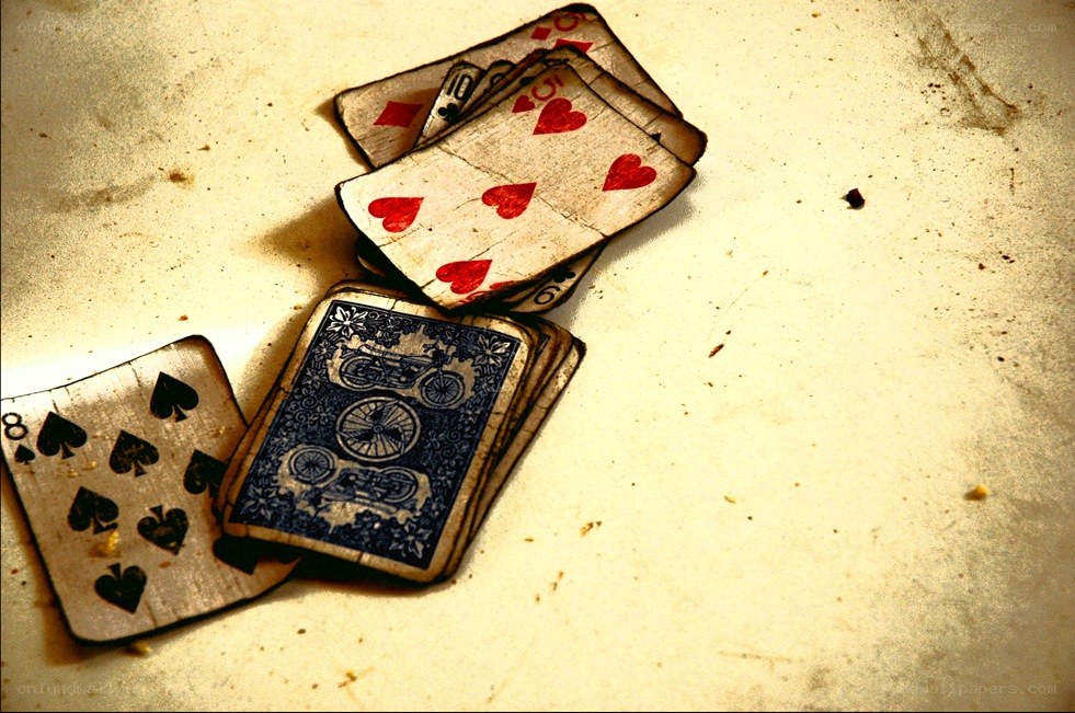 worn playing cards on a surface