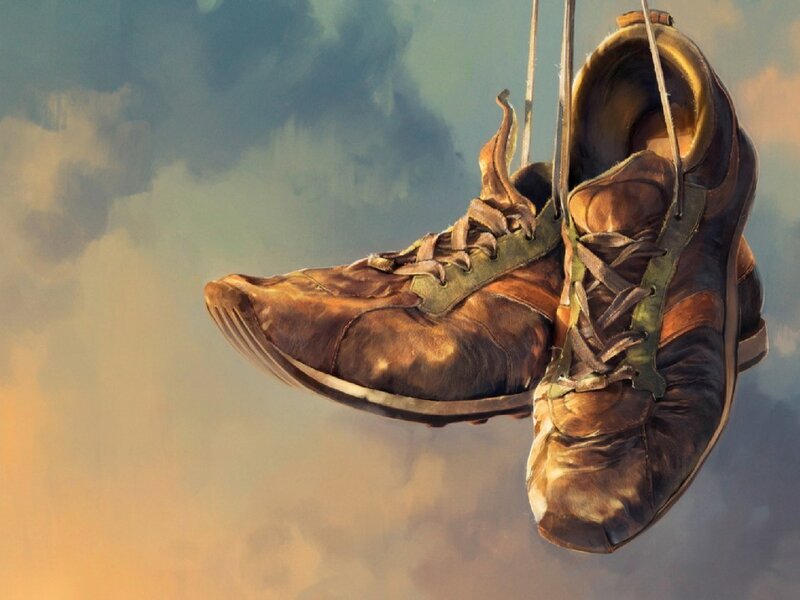 worn shoes hanging in the sky