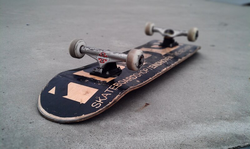 Worn Skateboard on Pavement — Black