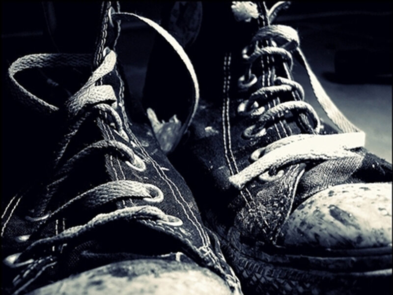worn sneakers in black and white