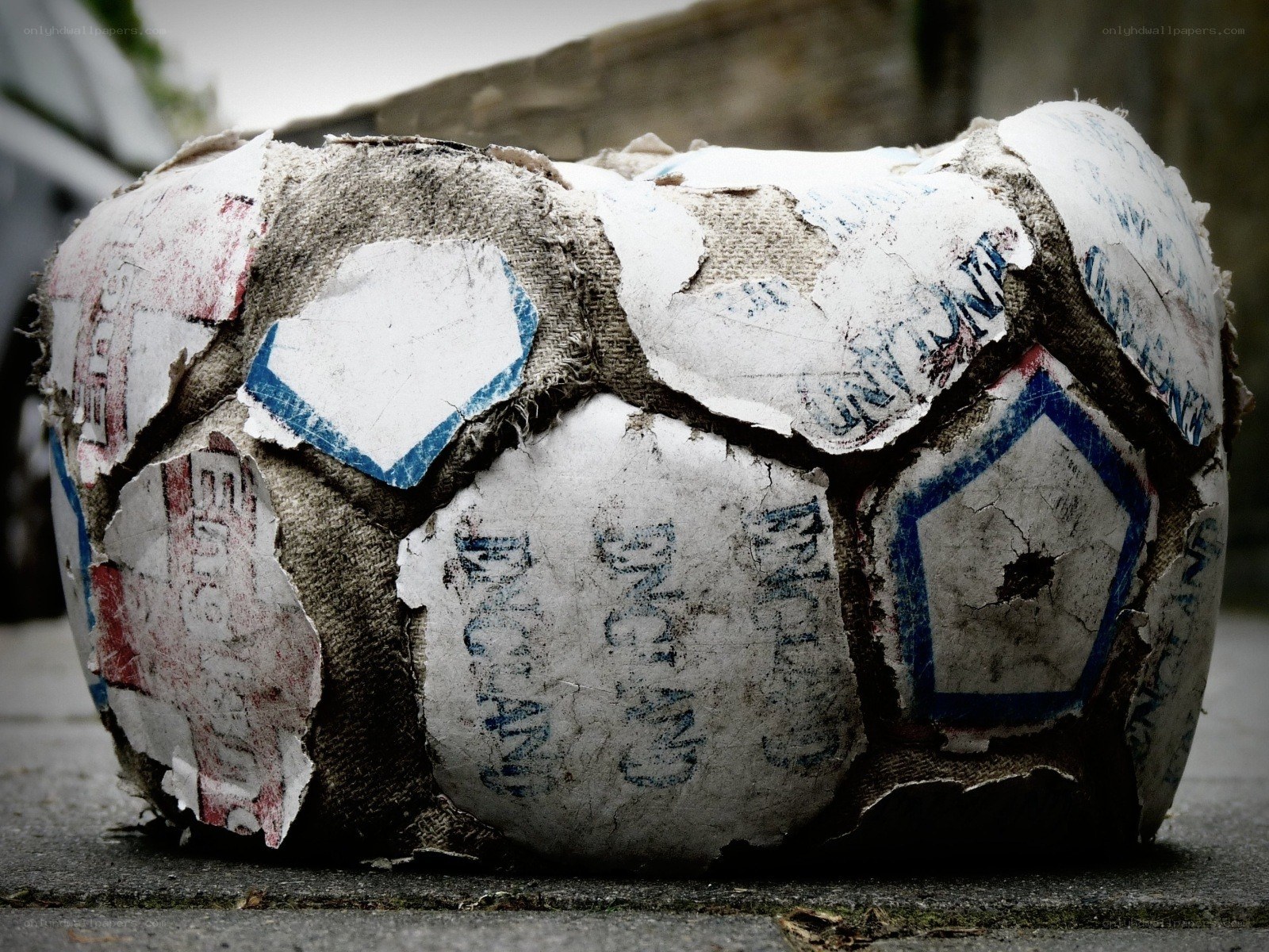 worn soccer ball on pavement