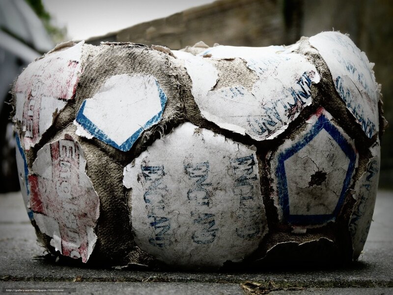 Worn soccer ball on pavement