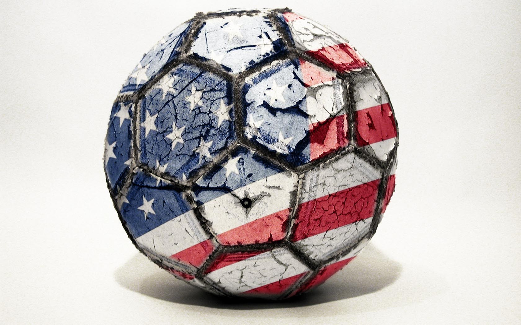 worn soccer ball with flag design
