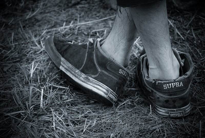 worn Supra sneakers on grass