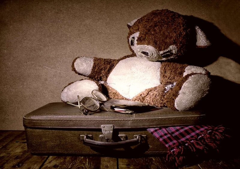 Worn Teddy Bear on Suitcase
