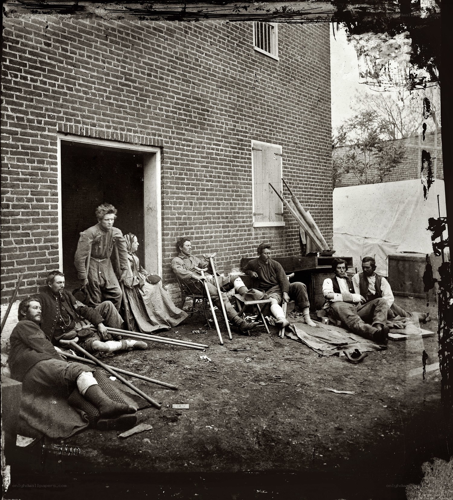 Wounded soldiers outside a brick building
