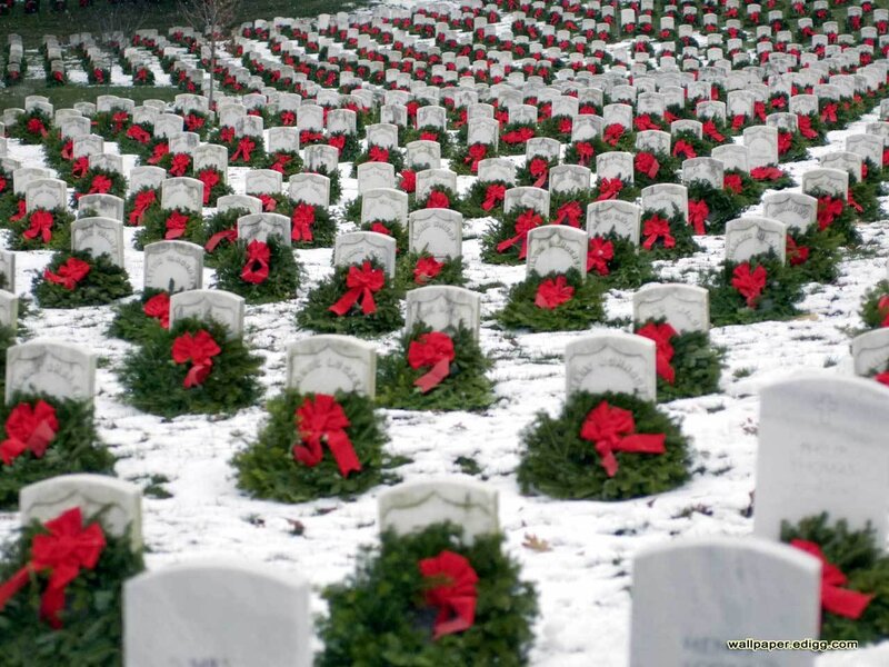 Wreaths at a snowy cemetery