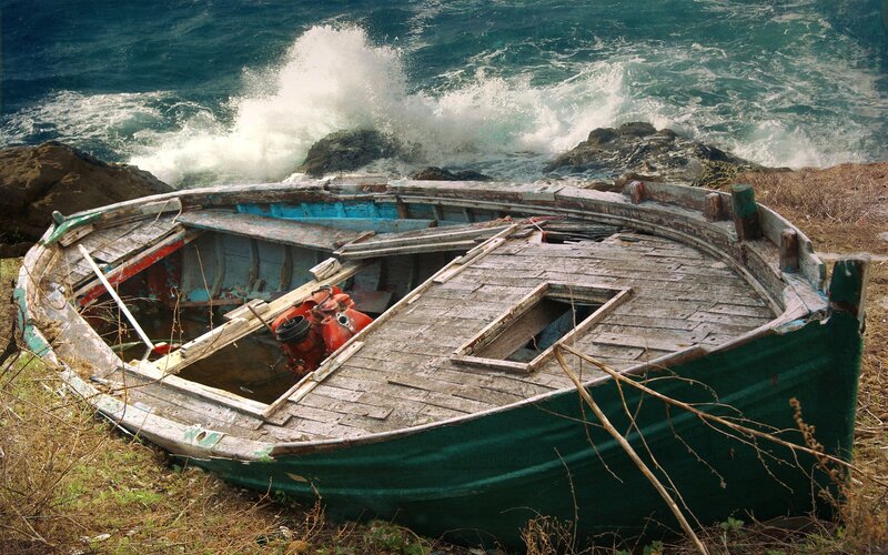 Wrecked boat on rocky shore