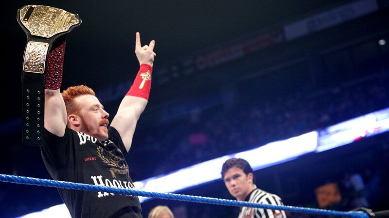wrestler holding championship belt