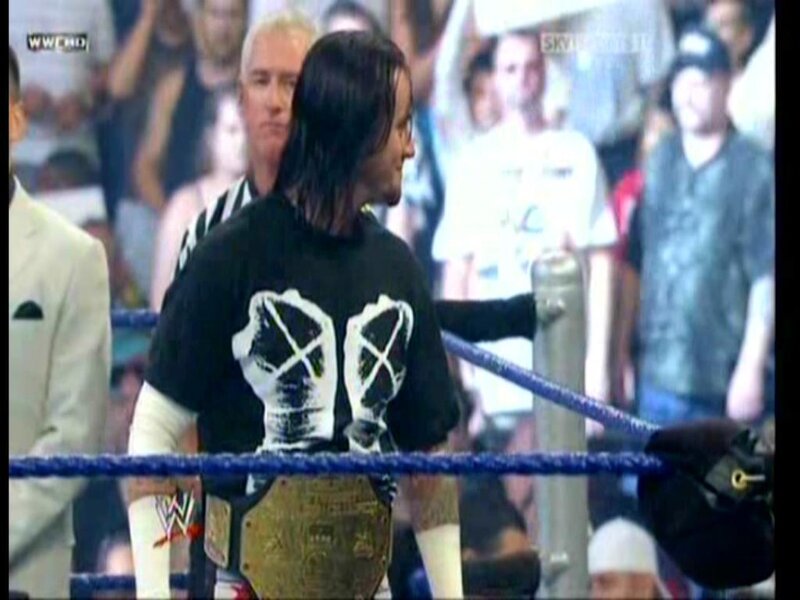 wrestler in ring with championship belt