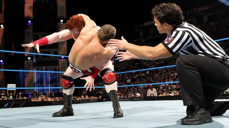 Wrestlers in ring with referee