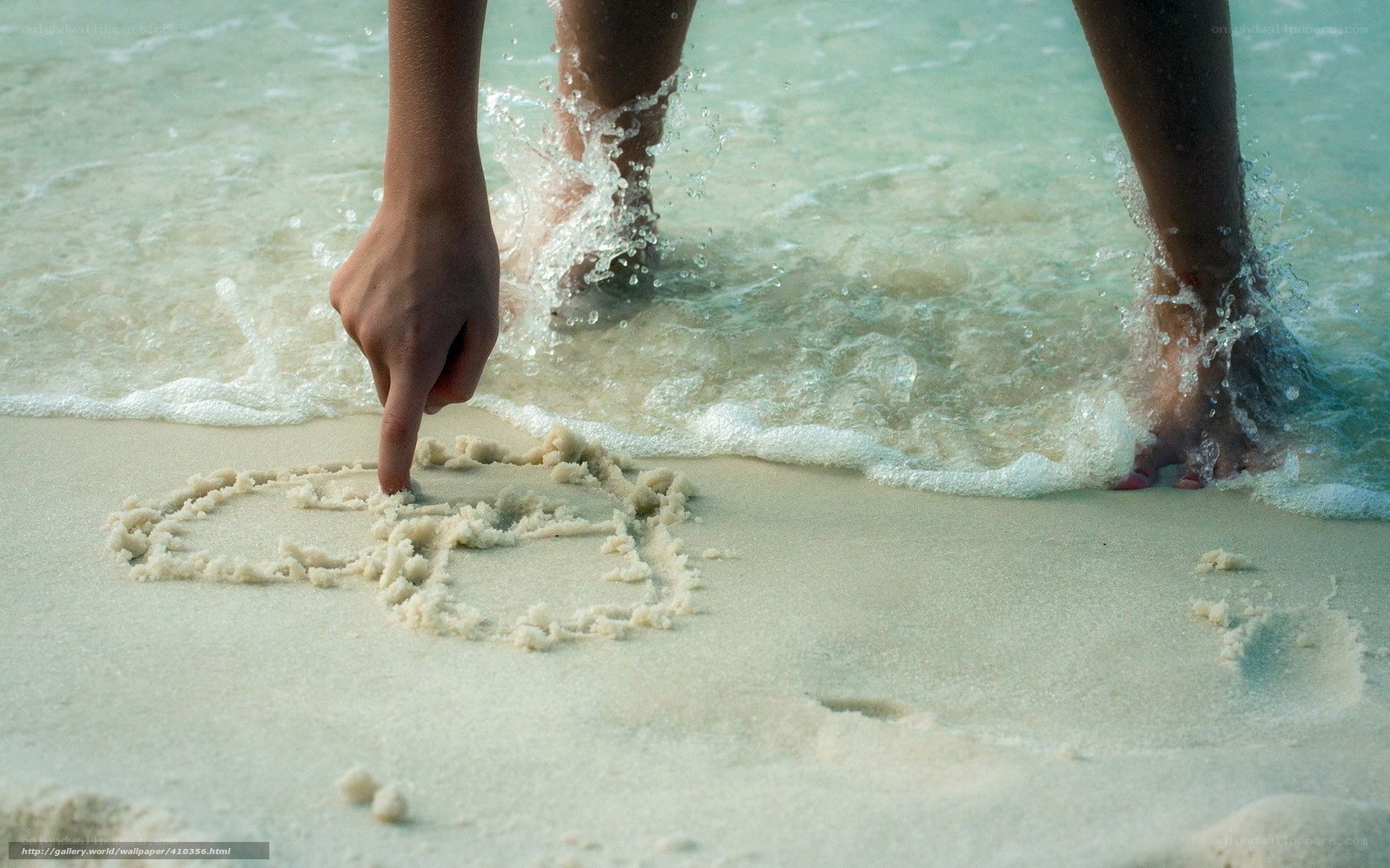 writing in the sand at the beach