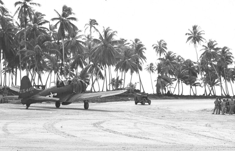 WWII aircraft on tropical airfield