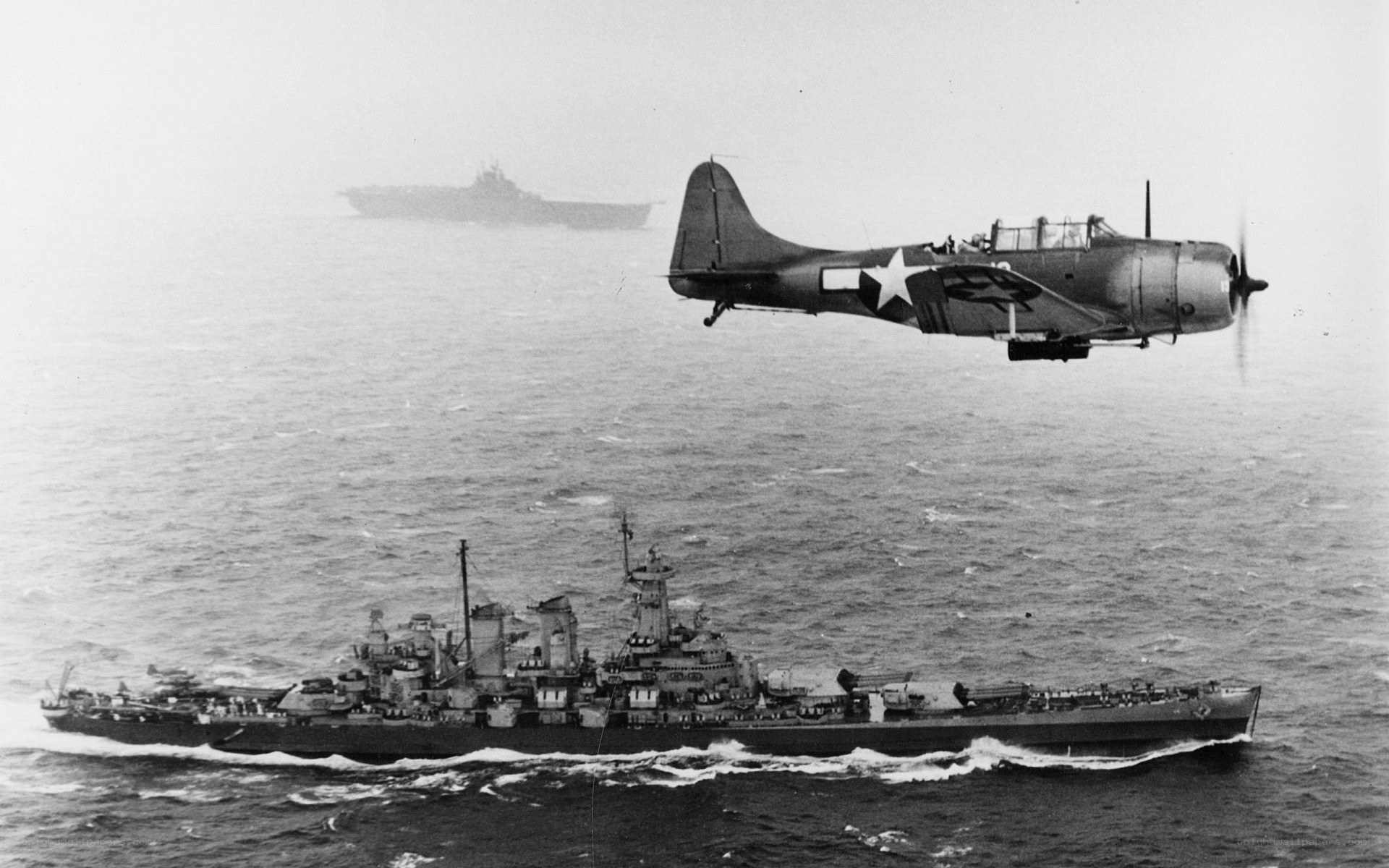 WWII aircraft over warship