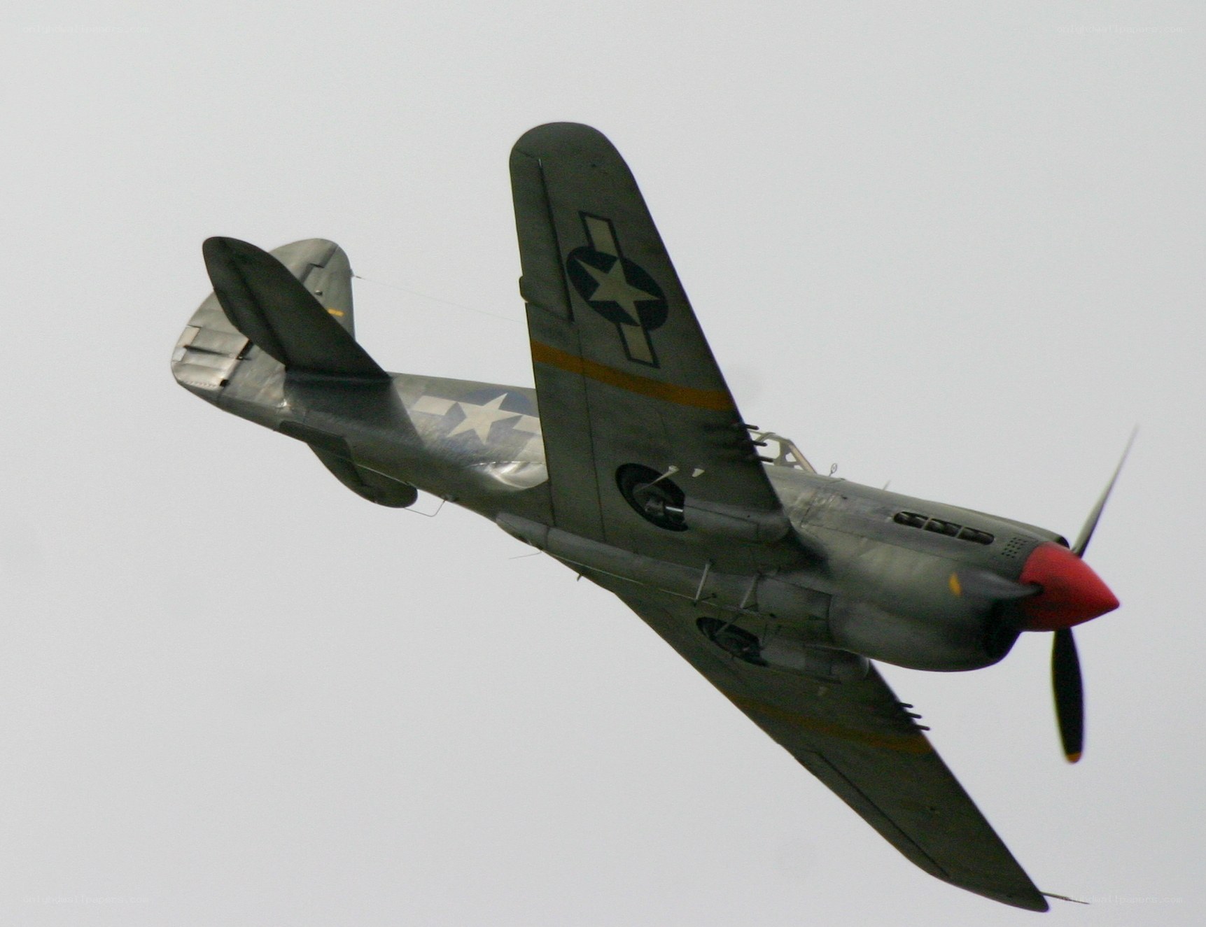 WWII-era fighter plane in flight