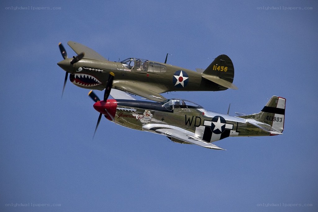WWII-era fighter planes in flight
