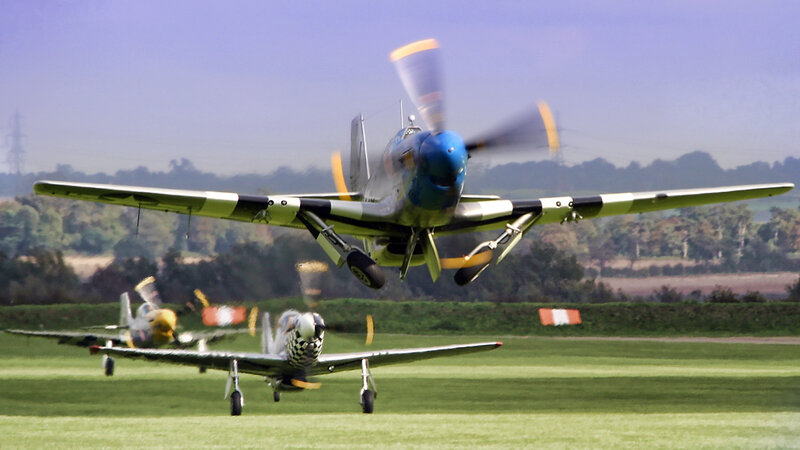 WWII fighter planes on a field