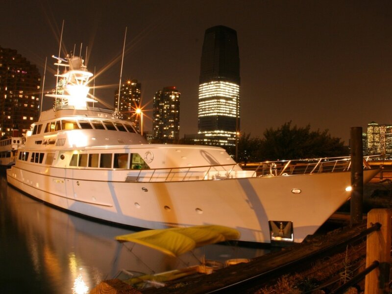Yacht docked at night in city