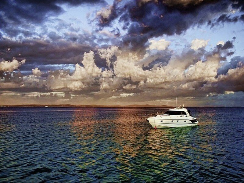 Yacht on calm sea at sunset