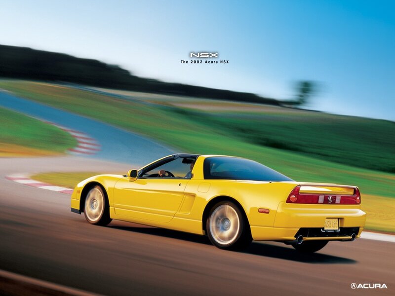 Yellow Acura NSX on a racetrack