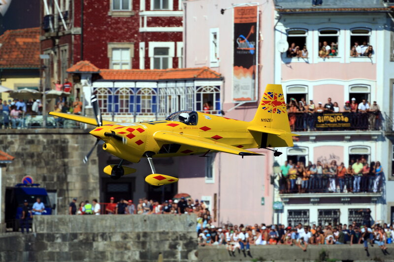 Yellow aerobatic plane in flight