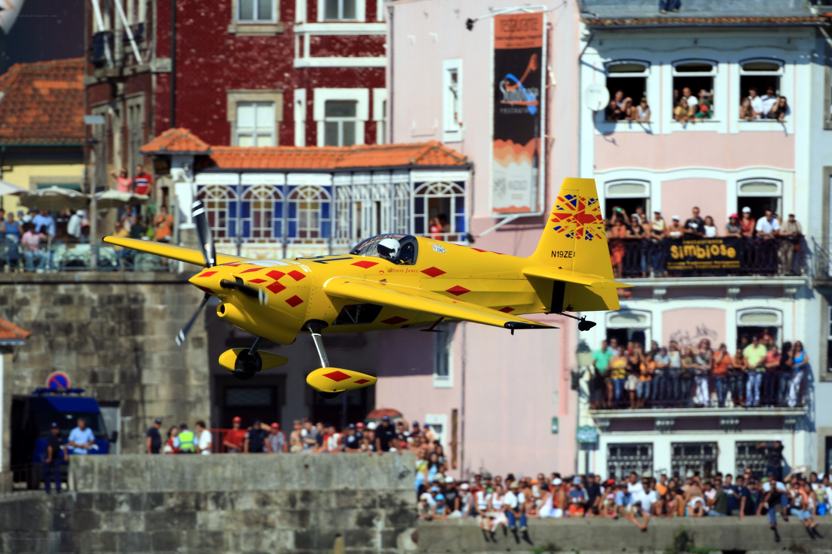 Yellow aerobatic plane in flight