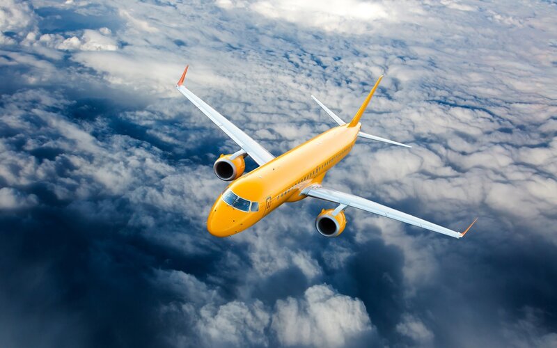 Yellow Airplane in Clouds