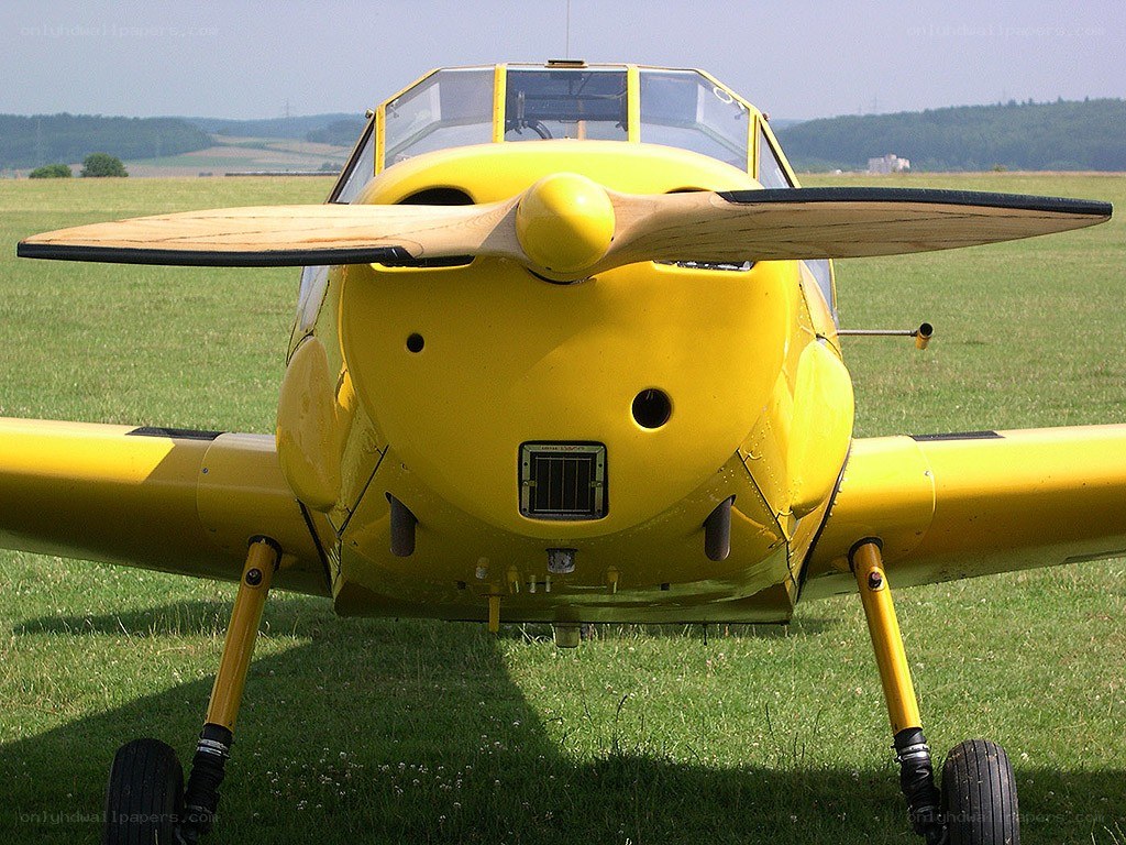 yellow airplane on grass field